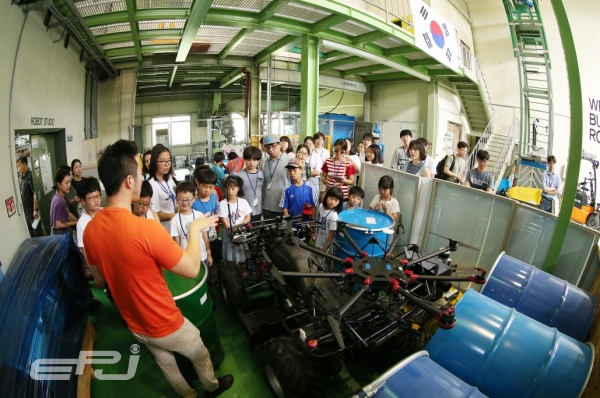 '2018년 여름방학 ‘연구원 개방의 날’ 프로그램에서 로봇 연구실을 견학하고 있는 참가자들.