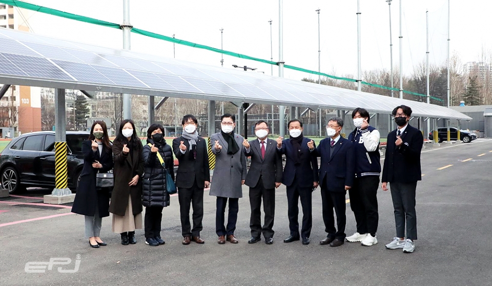 김중식 서울에너지공사 사장(오른쪽 다섯 번째)이 배재고 주차장에 설치된 태양광설비에서 관계자들과 기념촬영을 하고 있다.